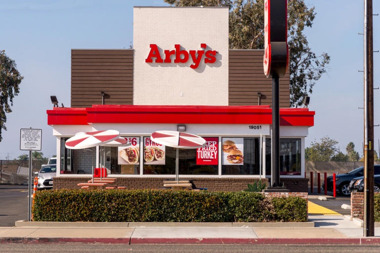 Exterior of a Arby's restaurant during arby's happy hour.